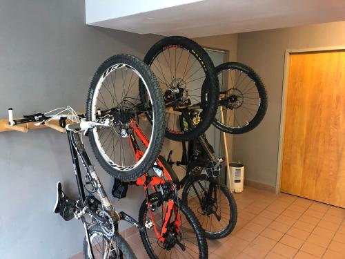two bikes are hanging on a wall at Hotel Flattacher Hof in Flattach