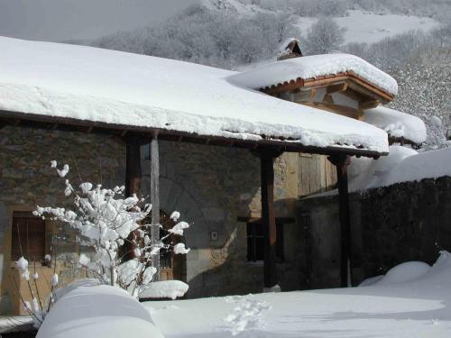 a house with snow on the roof of it at Etxatoa in Odériz