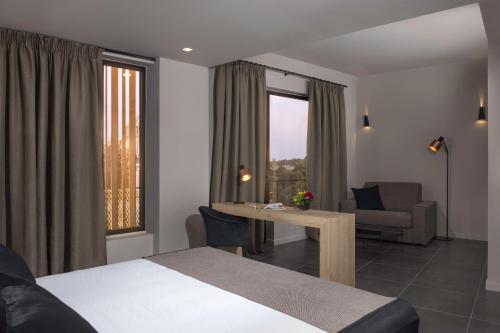 a hotel room with a bed and a table and chairs at Azur Suites in Athens