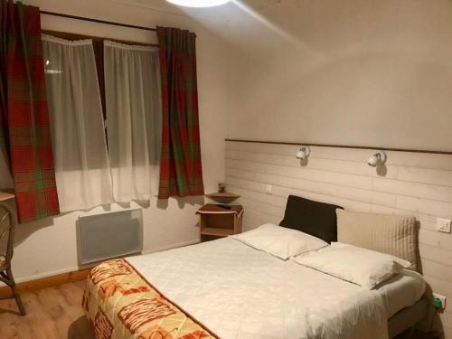 a bedroom with a large white bed in front of a window at AUBERGE SAINT MICHEL in Saint-Martin-dʼUriage