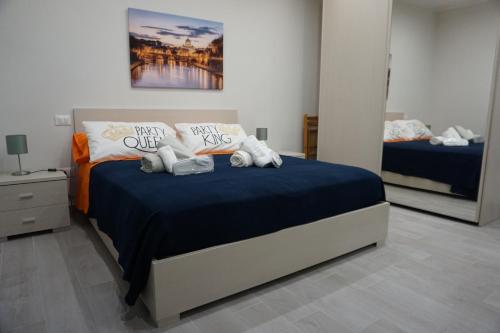 a bedroom with a bed with blue sheets and pillows at Boccy Brothers in Formia
