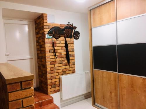 a room with a motorcycle hanging on a brick wall at Underground apartment Bratislava-Nivy in Bratislava