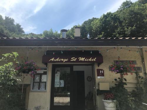 a building with a sign that reads archaeology s melted at AUBERGE SAINT MICHEL in Saint-Martin-dʼUriage