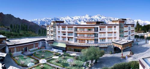 an aerial view of a hotel with mountains in the background at The Grand Dragon Ladakh in Leh