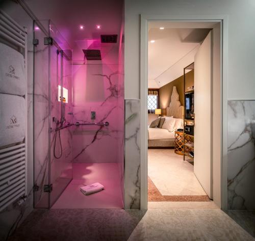 a bathroom with a shower with pink lighting at Excess Venice Boutique Hotel & Private Spa - Adults Only in Venice