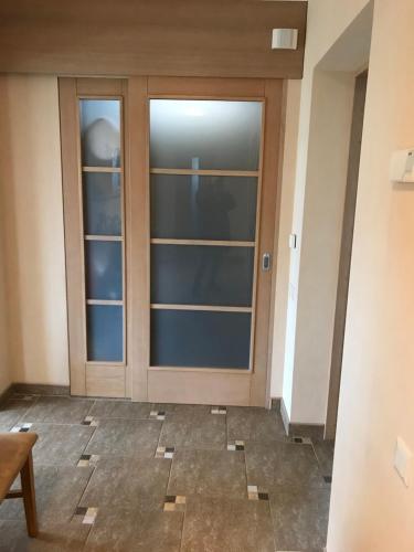 a glass door in a room with a floor at House on the sea side in Ragaciems