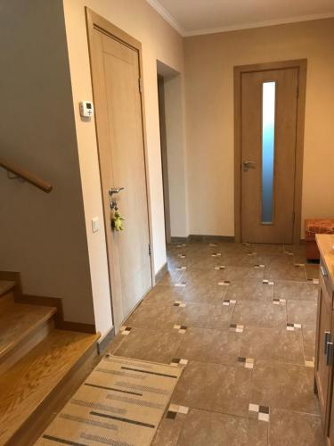 a hallway with a tile floor and a door at House on the sea side in Ragaciems
