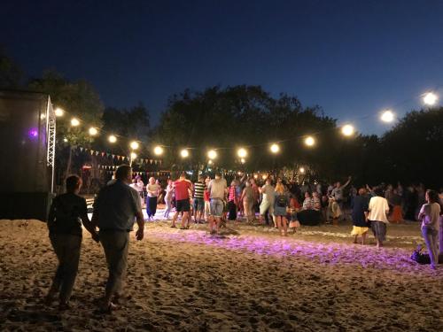 a group of people walking on the beach at night at House on the sea side in Ragaciems