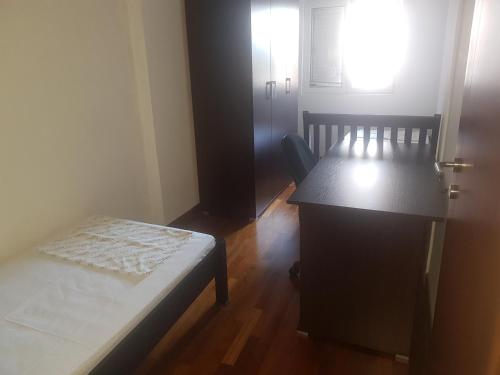 a room with a bed and a desk and a window at Bujic Apartment in Petrovac na Moru