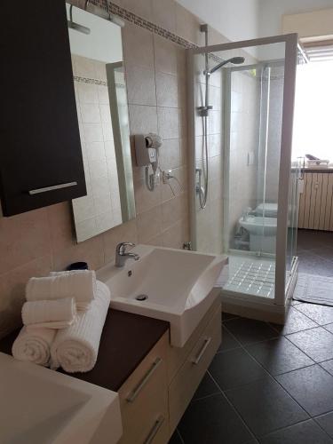a bathroom with a sink and a shower and a mirror at CAV Diamond by People in Asti
