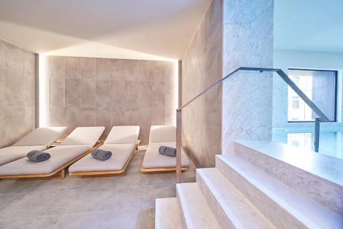 a room with four beds in it with stairs at PortoBay Flores in Porto
