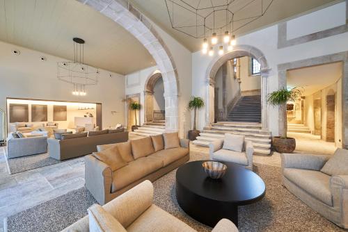 a living room with couches and a table at PortoBay Flores in Porto