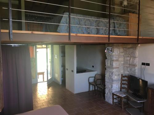 a room with a bunk bed and a living room at I Casali del Trebbiolo in Molino del Piano