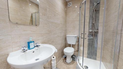 a bathroom with a toilet and a sink and a shower at StayZo Westminster Stylish House Accommodation in Bradford