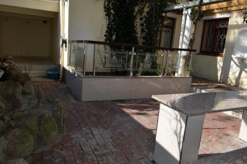 a stone bench sitting in front of a building at ST@Y-1-BnB in Cape Town