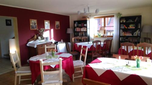 a dining room with tables and chairs with red walls at "Campingplatz Altjessen 57" in Pirna