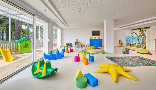 a room with many different types of play equipment at Hipotels Mediterraneo Club in Sa Coma