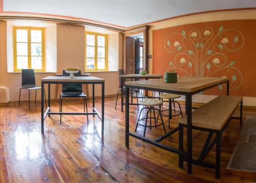 a room with tables and chairs and a wall at Ca’d’ambra in Groscavallo