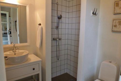 a bathroom with a sink and a shower at Pension Lærkelill in Skovlund
