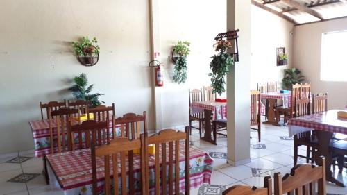a restaurant with tables and chairs in a room at Pousada da Orla in Salinópolis