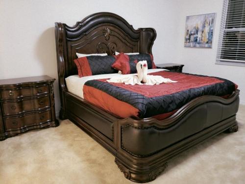a bedroom with a large bed with a wooden frame at G7009-New House Disney-Universal Studios in Davenport