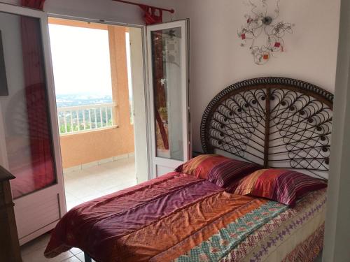 a bedroom with a bed and a window with a view at ELI&LOU avec piscine et voiture in Alata