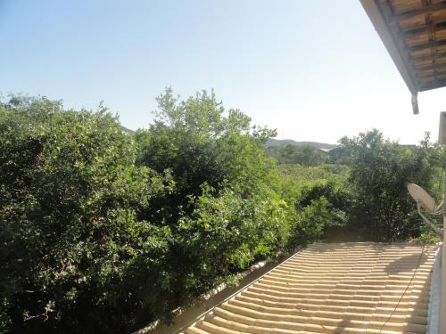 ein Gehweg führt zu einem Haus mit Bäumen in der Unterkunft LA DORITA in Búzios