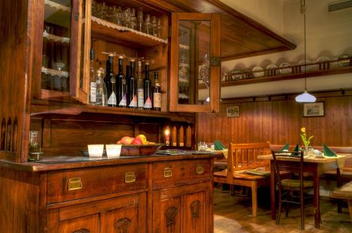 a kitchen with a bar with a table and wine bottles at Hotel Gasthof König in Kremsmünster