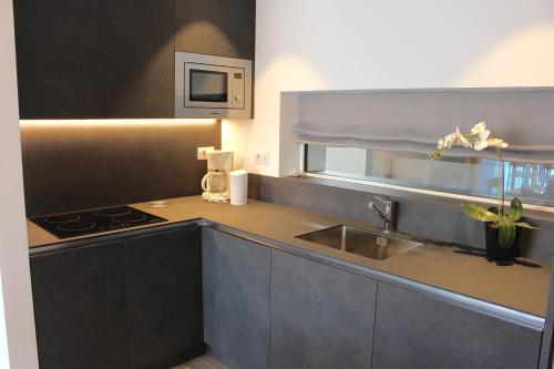 a kitchen with a sink and a counter top at My Lake Apartments in Malcesine