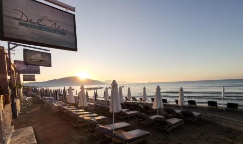 a group of umbrellas and chairs on a beach at Casa Del Mar in Laganas
