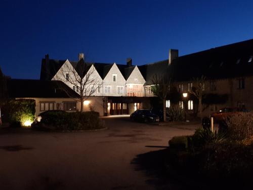 a large house at night with its lights on at Cricklade House Hotel, Sure Hotel Collection by Best Western in Cricklade