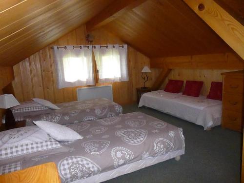 a attic bedroom with two beds and a couch at Chalet * Lioutraz * in Chamonix