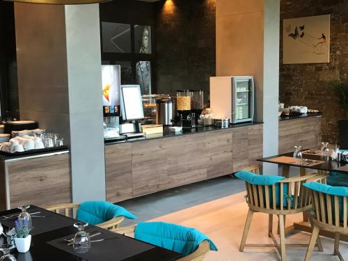 a restaurant with tables and chairs and a counter at Hotel Levadia in Levádeia