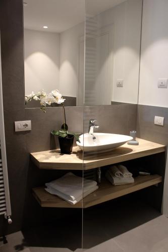 a bathroom with a sink and a mirror at My Lake Apartments in Malcesine