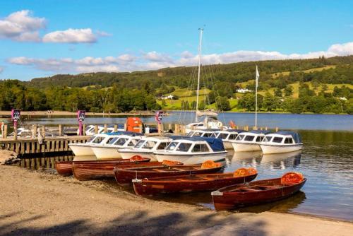 a group of boats are docked at a dock at Bluebird Lodge in Coniston