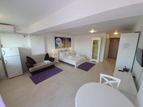 a living room with a couch and a table at Airport Residence in Otopeni