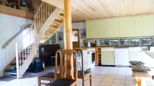 a kitchen with a staircase in a house at Fjøset på Knardal in Neset