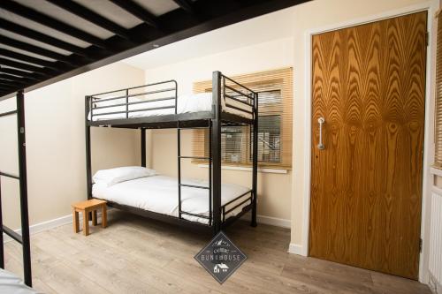 a bedroom with two bunk beds and a door at Celtic House in Merthyr Tydfil