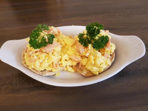 a plate of scrambled eggs on a wooden table at Grosvenor House Hotel in Torquay