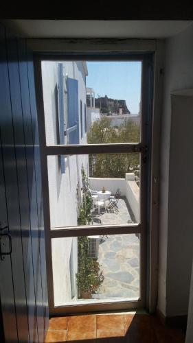 a view of a patio from an open window at The large bougainvillea house in Kýthira