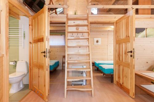 a treehouse with a toilet and a bunk bed at SOLEI in Pobierowo