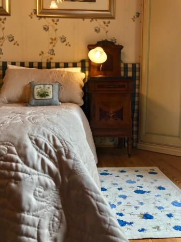 a bedroom with a bed with a blanket and a rug at Al Vecchio Fienile in San Michele al Tagliamento