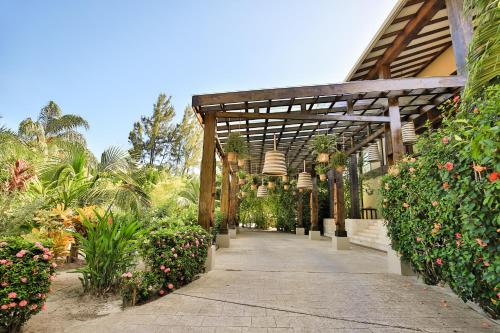 a walkway in a garden with flowers and plants at Umaya Resort & Adventures in Maya Beach