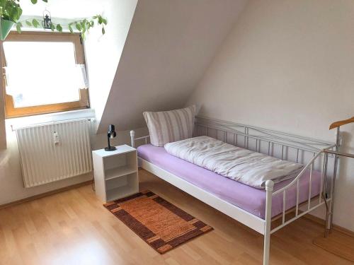 a small bedroom with a bed and a window at Gemütliche Fewo Angela 5 im Westerwald in Bad Marienberg