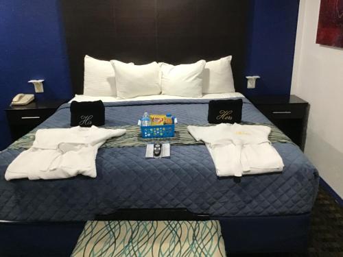 a hotel room with a bed with towels on it at Budget Inn & Suites in Oklahoma City