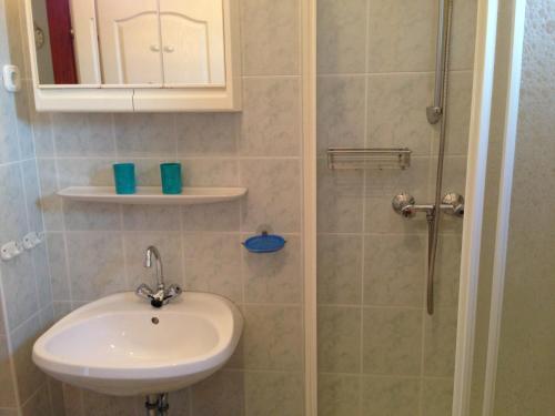 a bathroom with a sink and a shower at Villa Natalia in Hévíz