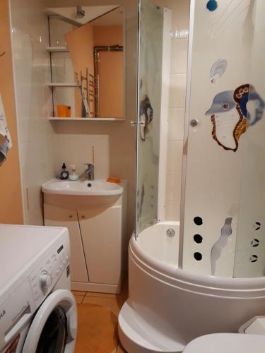 a bathroom with a shower and a toilet and a sink at Saulriets in Liepāja