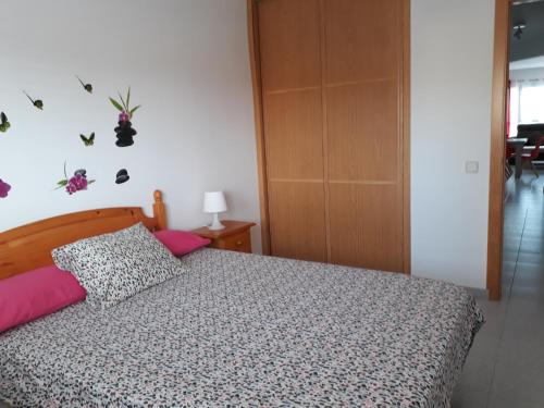 a bedroom with a bed with a bedspread and a pillow at Tu rincon en Playa de Melenara in Telde