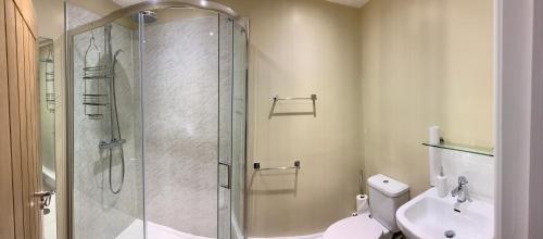 a bathroom with a shower and a toilet and a sink at Hassop Station rooms on the Monsal Trail in Bakewell