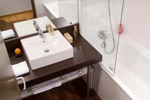 a bathroom with a sink and a shower at Madame Vacances Les Cottages De Valjoly in Eppe-Sauvage